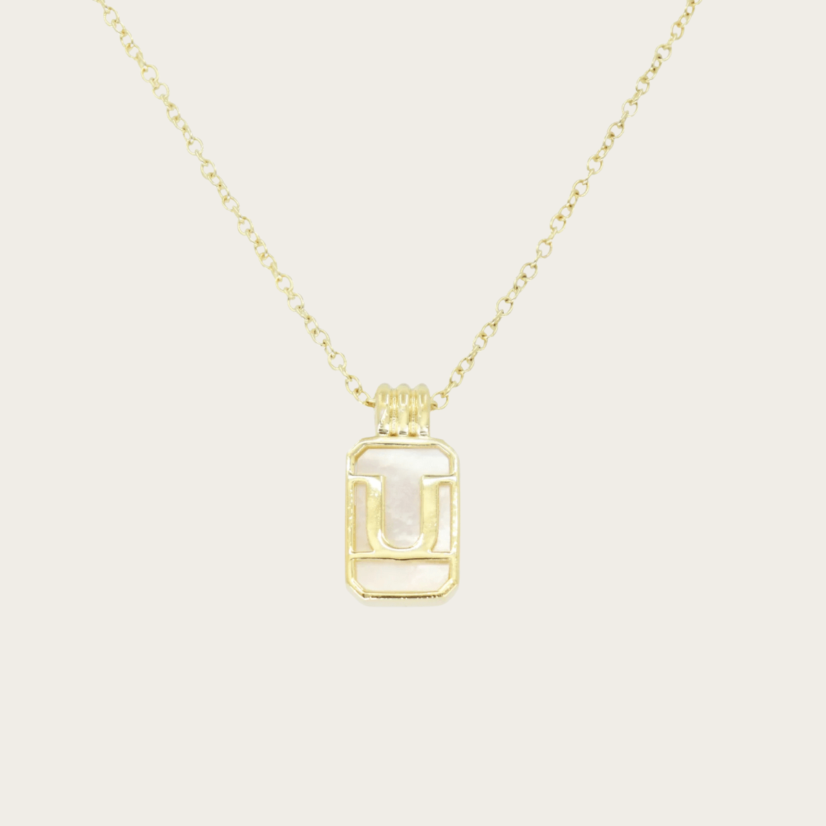 Collar de oro con inicial de vidrio marino dorado